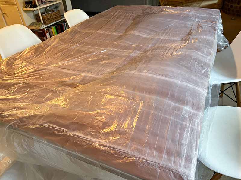 Kitchen Table with a Plastic Drop Cloth