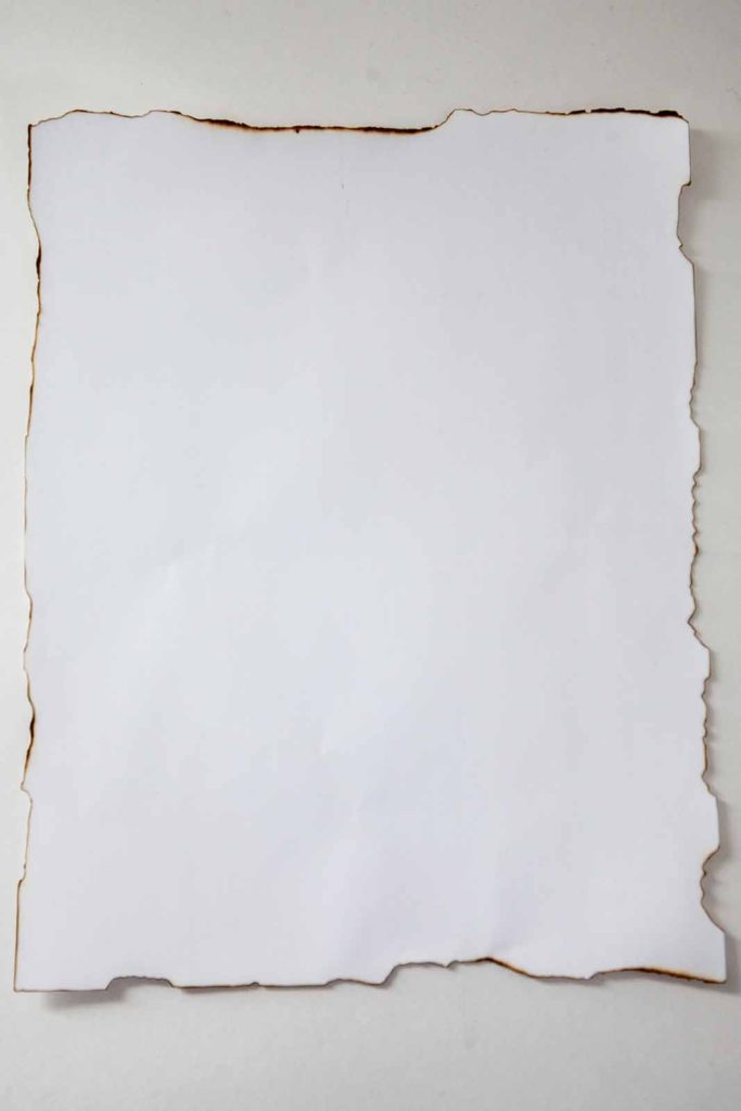 Paper with torn and burned edges