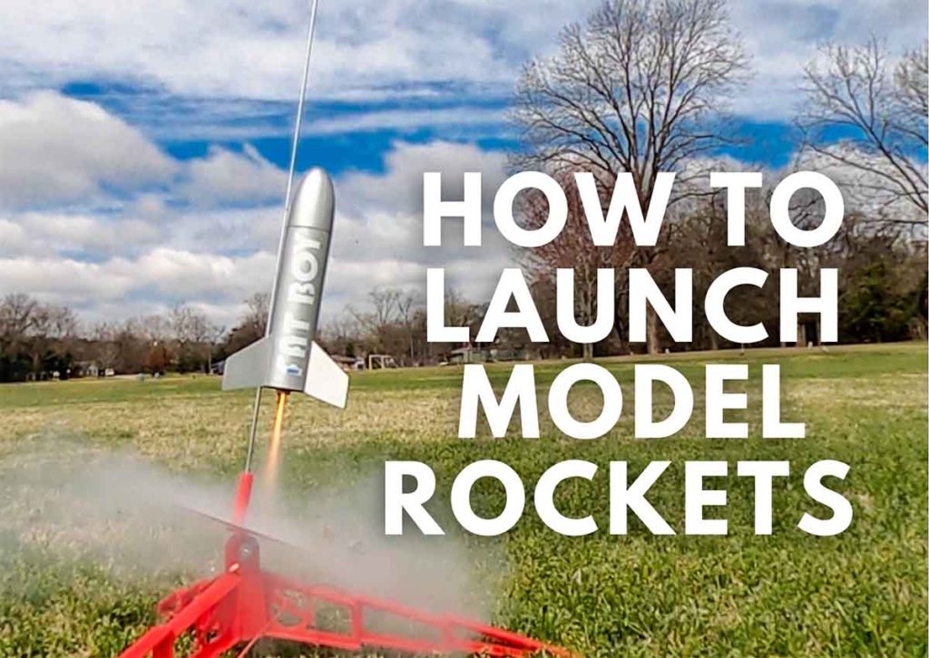 Model rocket launching off launch pad