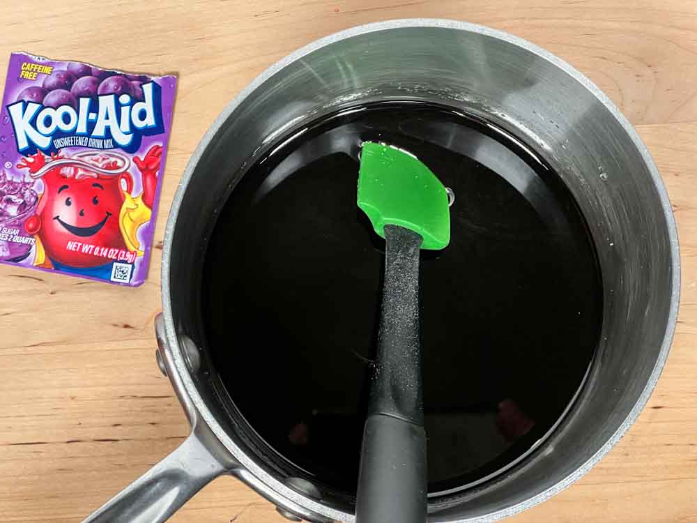 1/2 cup water, Kool-Aid, sugar, and corn syrup in a small saucepan