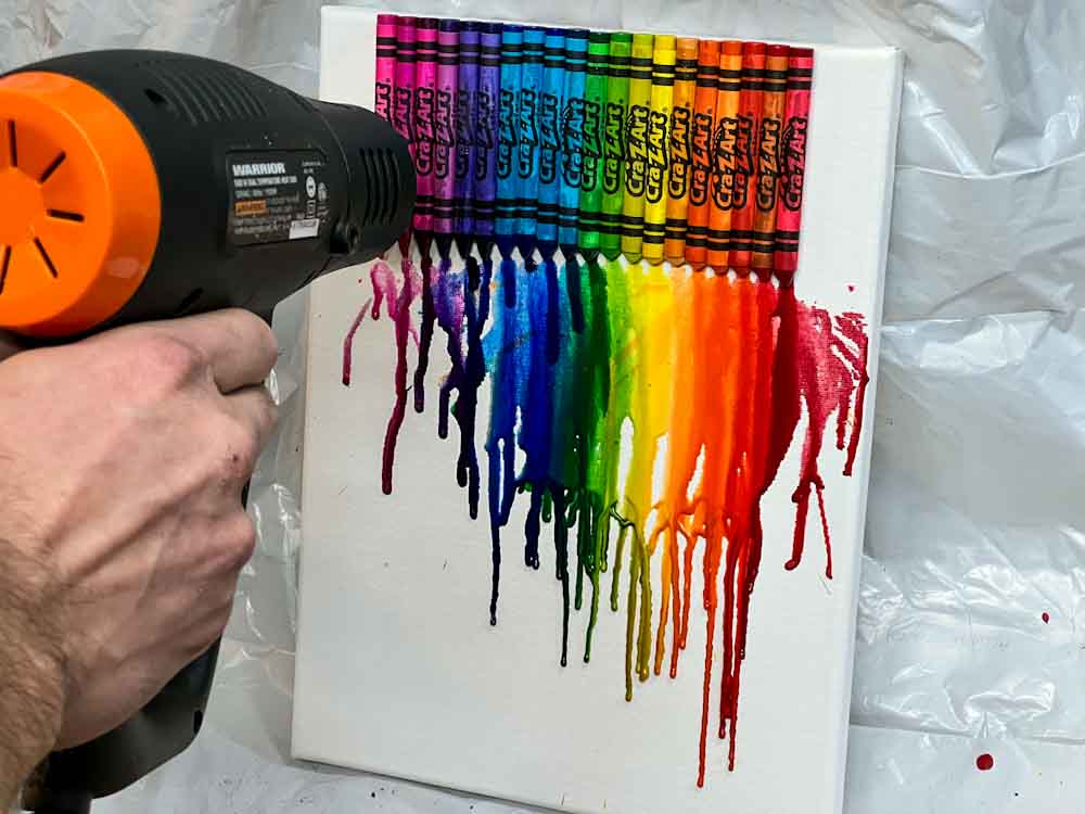 Melting crayons on a white canvas with a heat gun