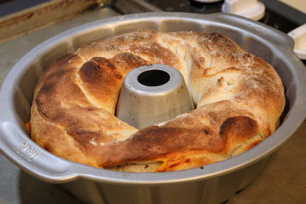 Baked rolled up pizza in a bundt pan