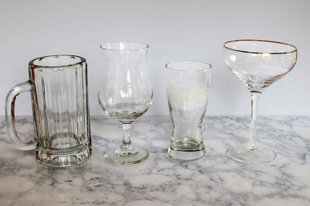 Different beer/champagne glasses (from left to right): beer stein, tulip glass, half-pint glass, coupe glass