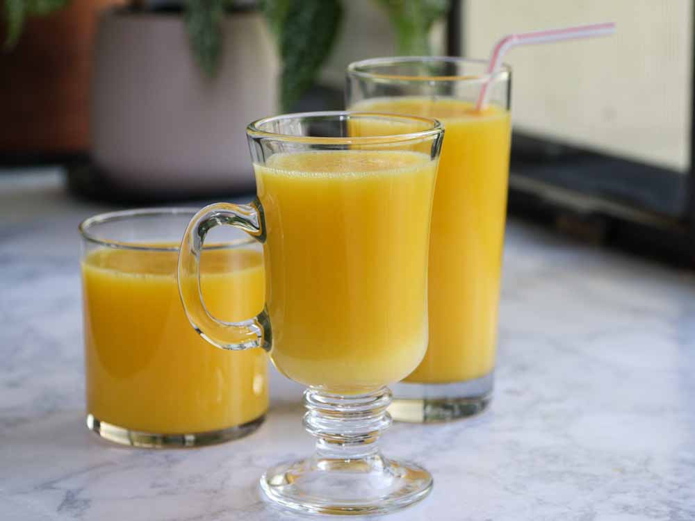 Orange jello juice in 3 different glasses